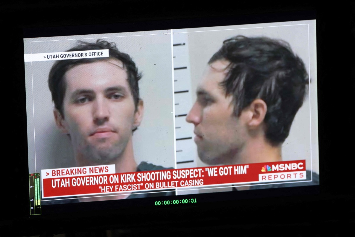 A TV monitor displays a picture of Tyler Robinson, the suspected of killing Charlie Kirk on September 11, in Orem, Utah, on September 12, 2025. (Photo by Patrick T. Fallon / AFP)