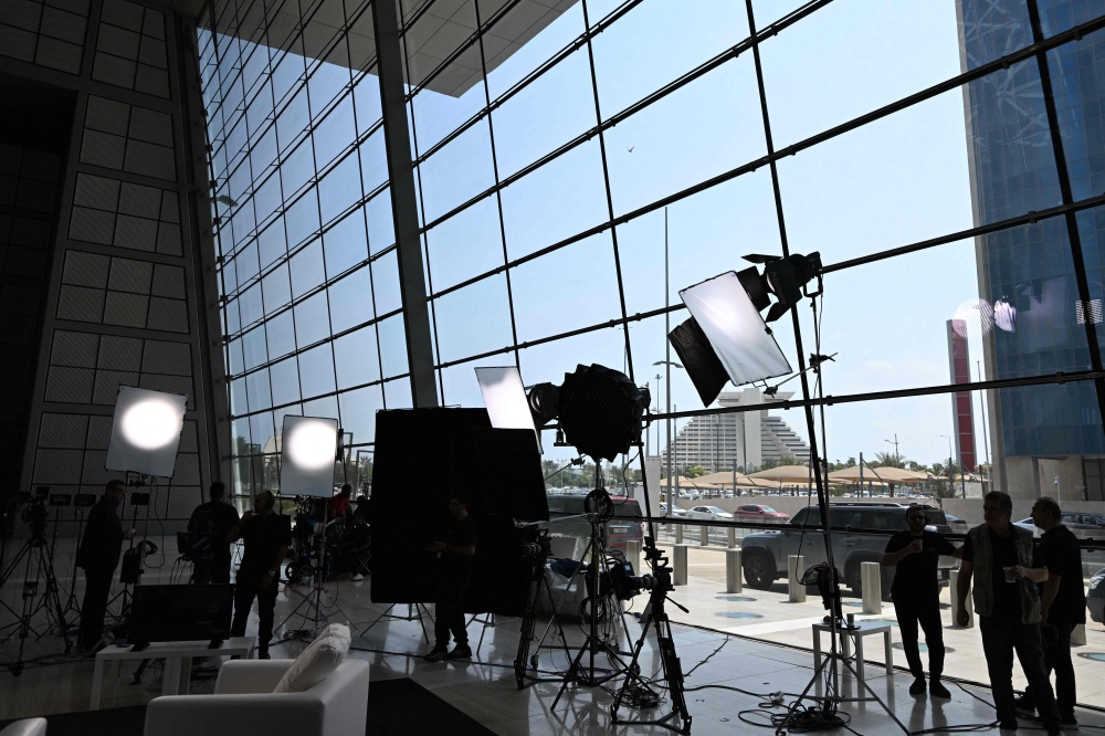 Members of the media gather at the press room reserved for the coverage of the upcoming Arab-Islamic summit in Doha on September 14, 2025. (Photo by Mahmud Hams / AFP)
 