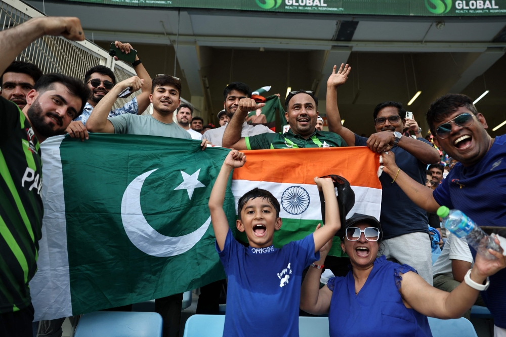 Pakistan and India fans cheer before the start of the Asia Cup 2025 Twenty20 international cricket match between India and Pakistan at the Dubai International Stadium in Dubai on September 14, 2025. (Photo by Fadel Senna / AFP)