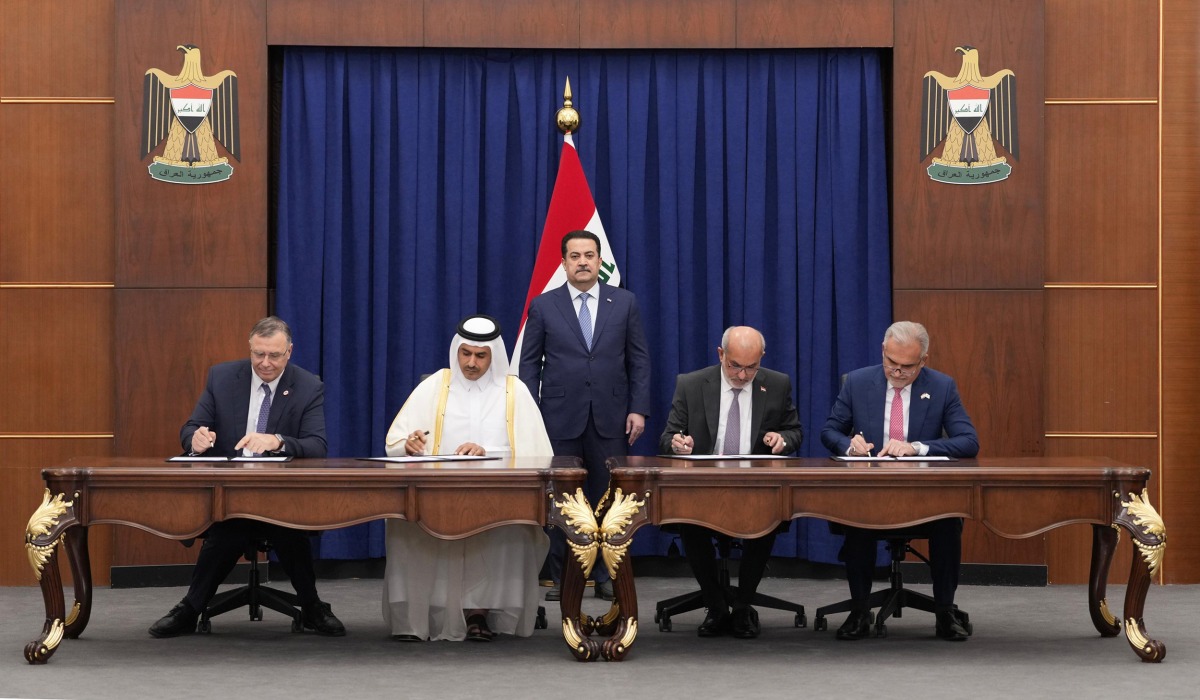 Prime Minister of Iraq H E Mohammed Shia Al-Sudani looks on as Minister of State for Energy Affairs, President and CEO of QatarEnergy, H E Saad Sherida Al-Kaabi; Chairman and CEO of TotalEnergies, Patrick Pouyanné; and other officials sign documents at a ceremony held in Baghdad yesterday.