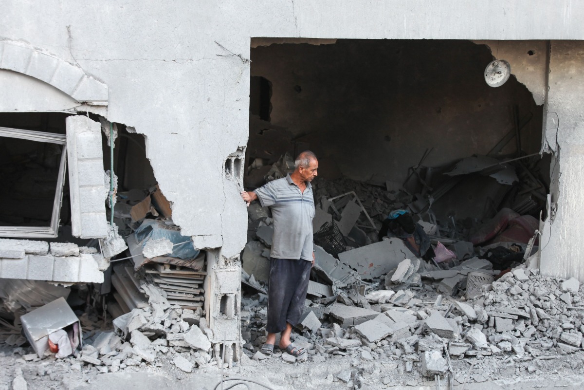 A Palestinian man reacts as he checks the rubble of a building hit by an Israeli strike in the Nuseirat refugee camp in the central Gaza Strip, on September 25, 2025, as Israel presses its air and ground offensive. (Photo by Eyad BABA / AFP)

