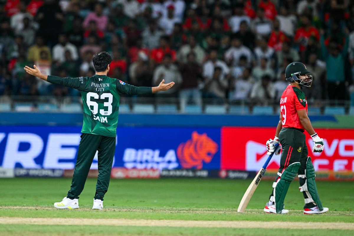 Pakistan's Saim Ayub (L) celebrates after dismissing Bangladesh's Nurul Hasan (R) during the Asia Cup 2025 Super Four Twenty20 international cricket match between Bangladesh and Pakistan at the Dubai International Stadium in Dubai on September 25, 2025. (Photo by Sajjad HUSSAIN / AFP)