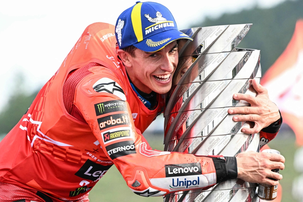 Ducati Lenovo Team's Spanish MotoGP rider Marc Marquez celebrates with the trophy after the MotoGP class race of the MotoGP Japanese Grand Prix at the Mobility Resort Motegi on September 28, 2025. (Photo by Toshifumi Kitamura / AFP)