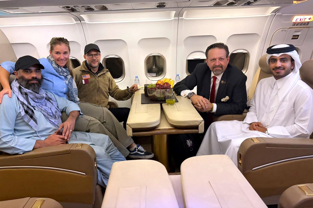 According to AFP, this handout picture released by Qatar's Ministry of Foreign Affairs (MoFA) shows American citizen Amir Amiri (left), along with US and Qatar officials. The group was onboard an aircraft following Amiri's release from detention in Kabul, Afghanistan. (Photo by AFP through MoFA handout)



