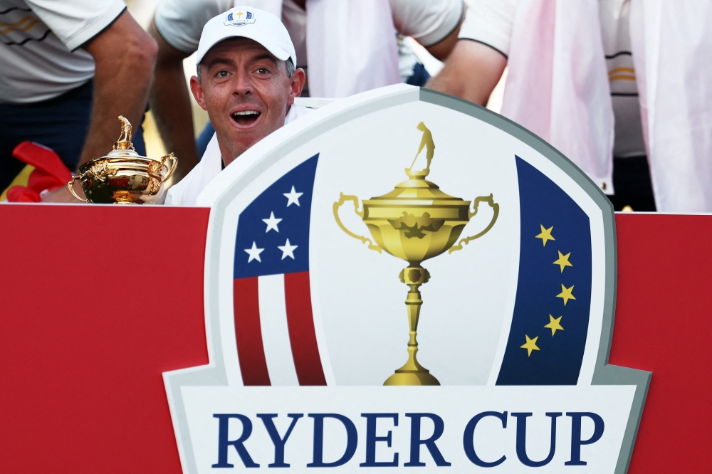 Rory McIlroy of Team Europe celebrates with the Ryder Cup after Team Europe's 15-13 win over Team United States on September 28, 2025 in Farmingdale, New York. Jared C. Tilton/Getty Images/AFP 