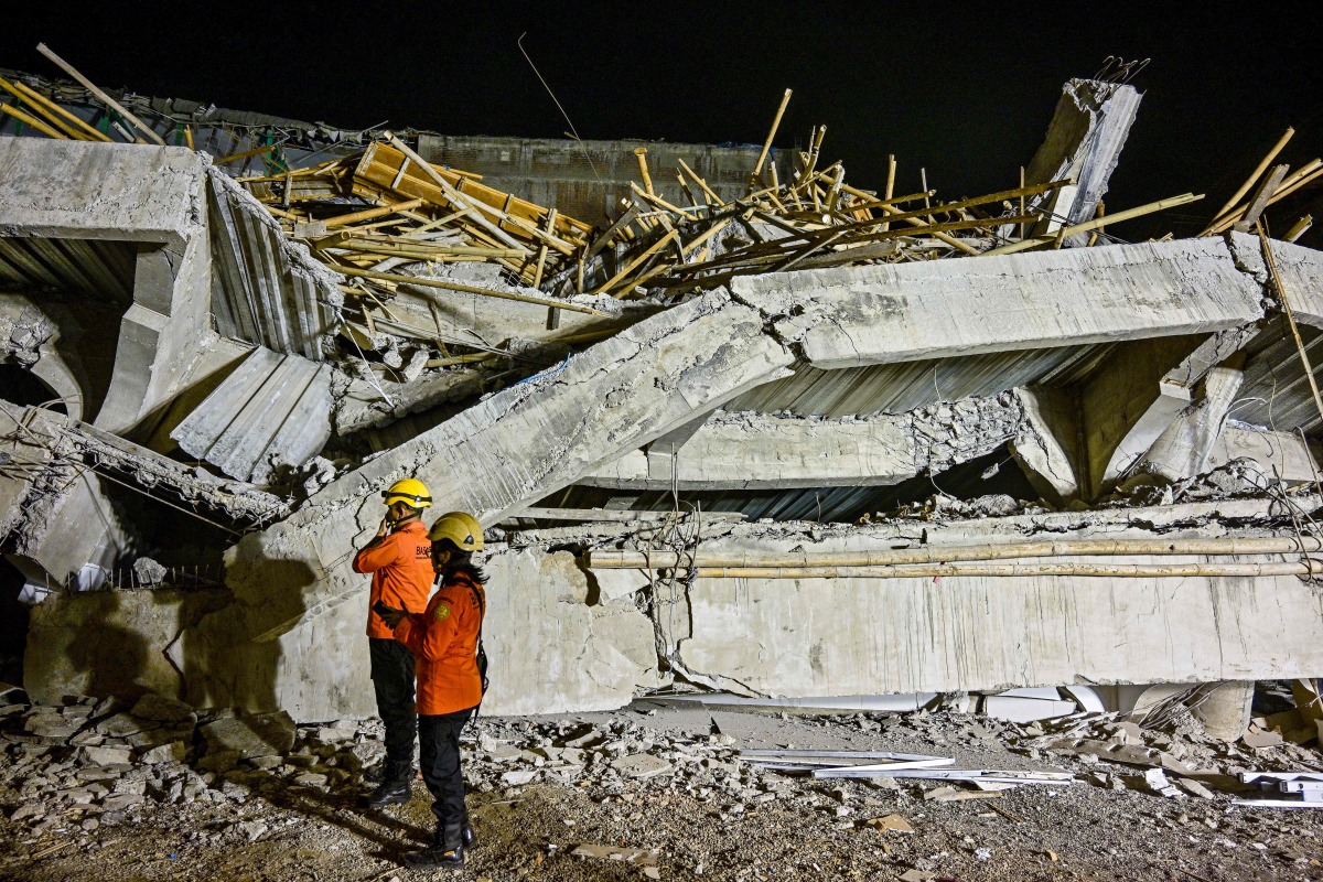 Rescue personnel inspect the site after a building collapsed at an Islamic boarding school in Sidoarjo, East Java province on September 29, 2025, injuring a number of students and trapping several others under the rubble. Photo by Juni KRISWANTO / AFP