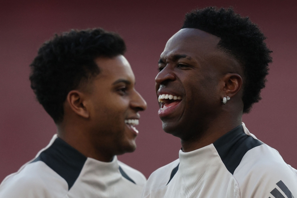 File: Real Madrid's Brazilian forward #11 Rodrygo (left) and Real Madrid's Brazilian forward #07 Vinicius Junior take part in a training session at the Emirates stadium in London on April 7, 2025. (Photo by Adrian Dennis / AFP)