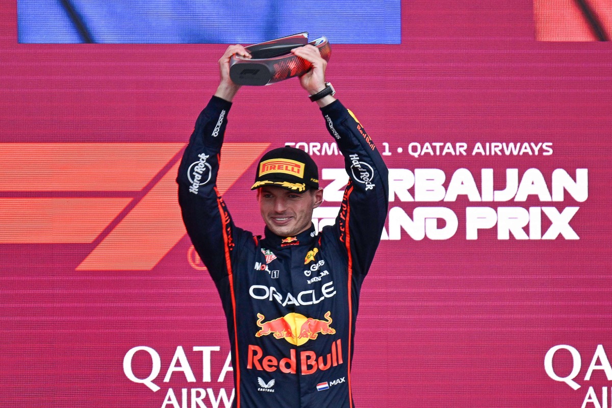 Red Bull Racing's Dutch driver Max Verstappen celebrates with his trophy on the podium after the Formula One Azerbaijan Grand Prix at the Baku City Circuit in Baku on September 21, 2025. (Photo by Alexander NEMENOV / AFP)

