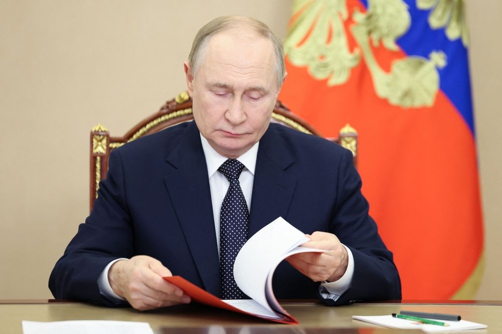 In this pool photograph distributed by the Russian state agency Sputnik, Russia's President Vladimir Putin holds an operational meeting via videoconference with permanent members of the Russian Security Council in Moscow on October 1, 2025. (Photo by Aleksey Babushkin / POOL / AFP)
