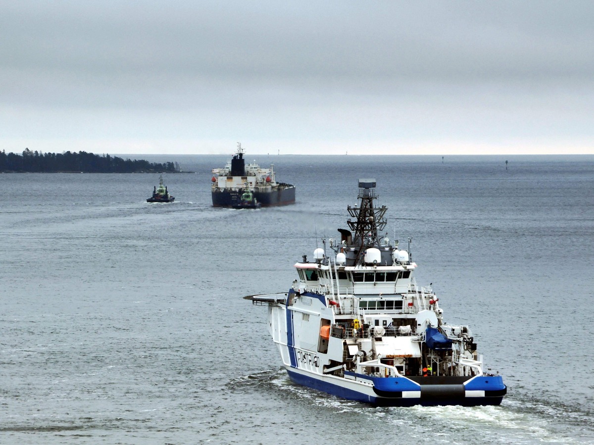 This handout picture taken and released by The Finnish Border Guard on March 2, 2025 shows the Border Guard ship Turva (front) escorting Cook Islands registered oil tanker Eagle S out to sea near Porvoo (Borga), Finland. Photo by Handout / various sources / AFP


