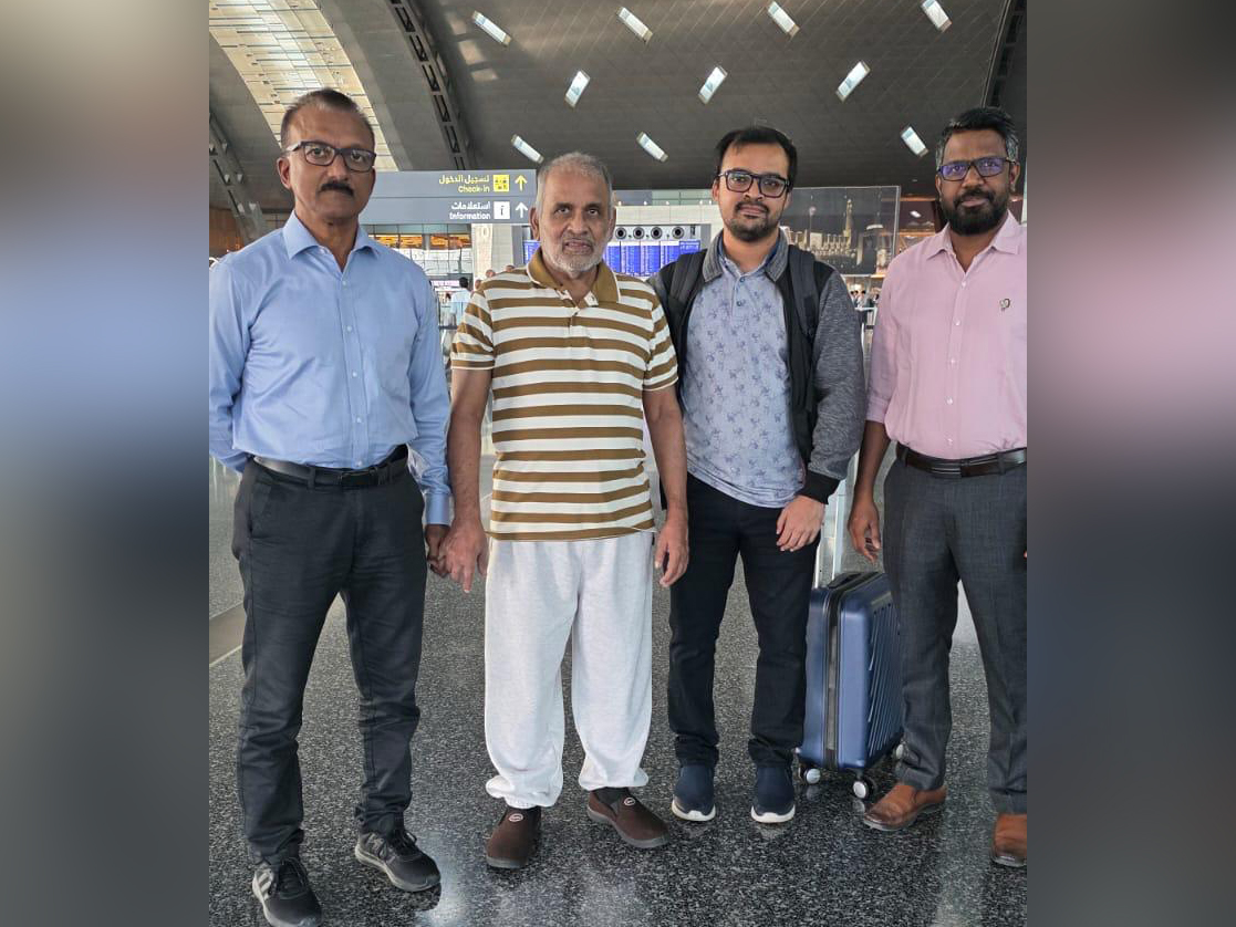 The elderly passenger with his son-in-law (second from right) along with Indian officials from Qatar 