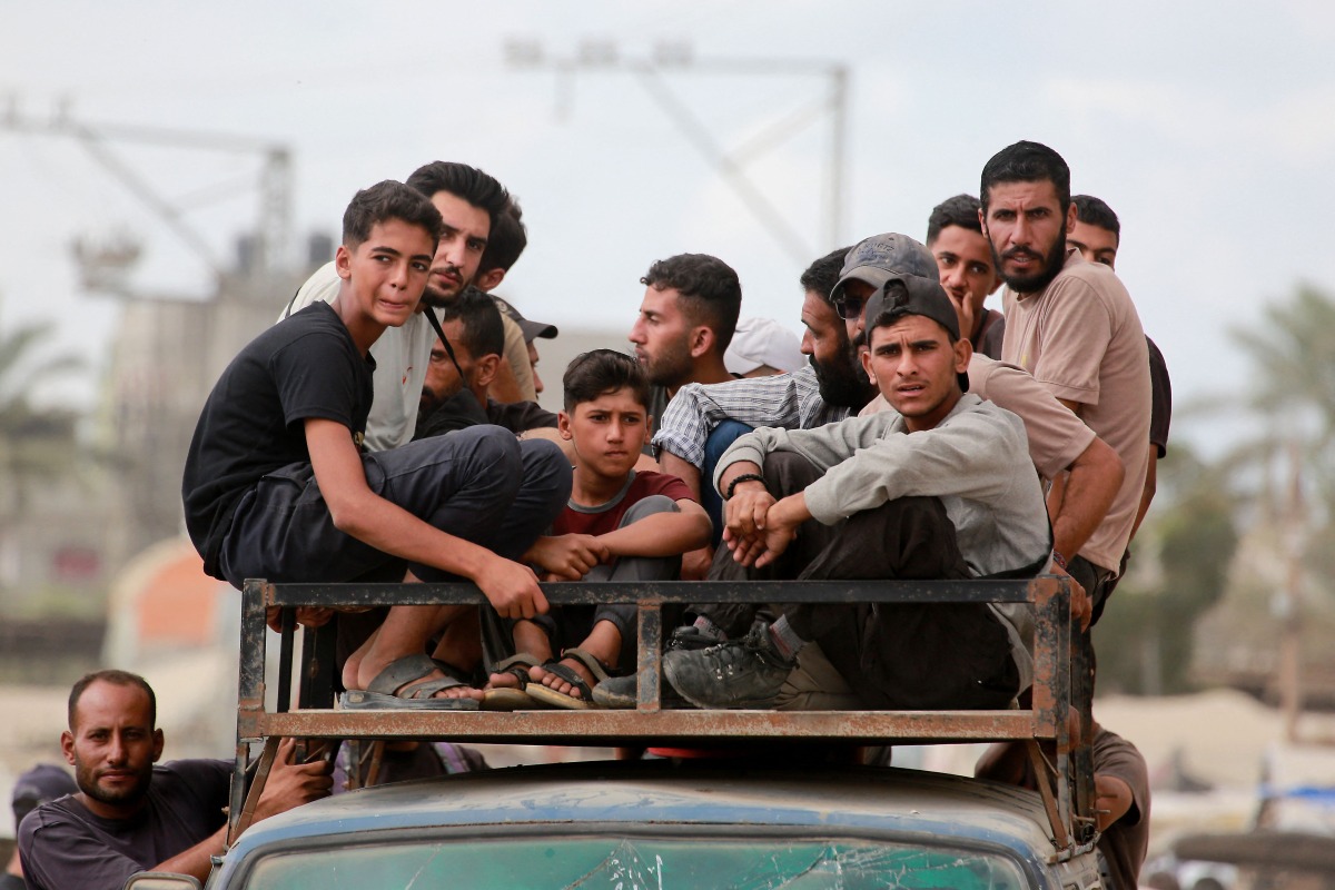 Displaced Palestinians ride a vehicle south of Deir El-Balah in the Central Gaza Strip yesterday.  ( AFP)