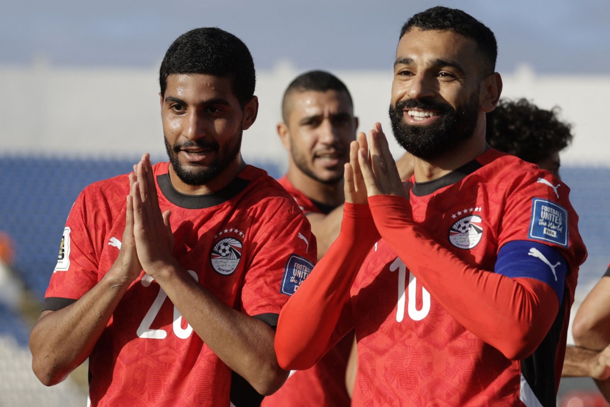 Egypt's forward #20 Ibrahim Adel celebrates with forward #10 Mohamed Salah after scoring his team's first goal during the FIFA World Cup 2026 Africa qualifier football match between Djibouti and Egypt at the Larbi Zaouli Stadium in Casablanca on October 8, 2025. (Photo by Abdel Majid BZIOUAT / AFP)
