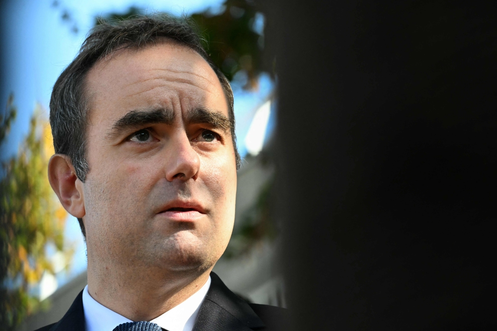 France's Prime Minister Sebastien Lecornu speaks to journalists on October 11, 2025. (Photo by Martin Lelievre / Pool / AFP)