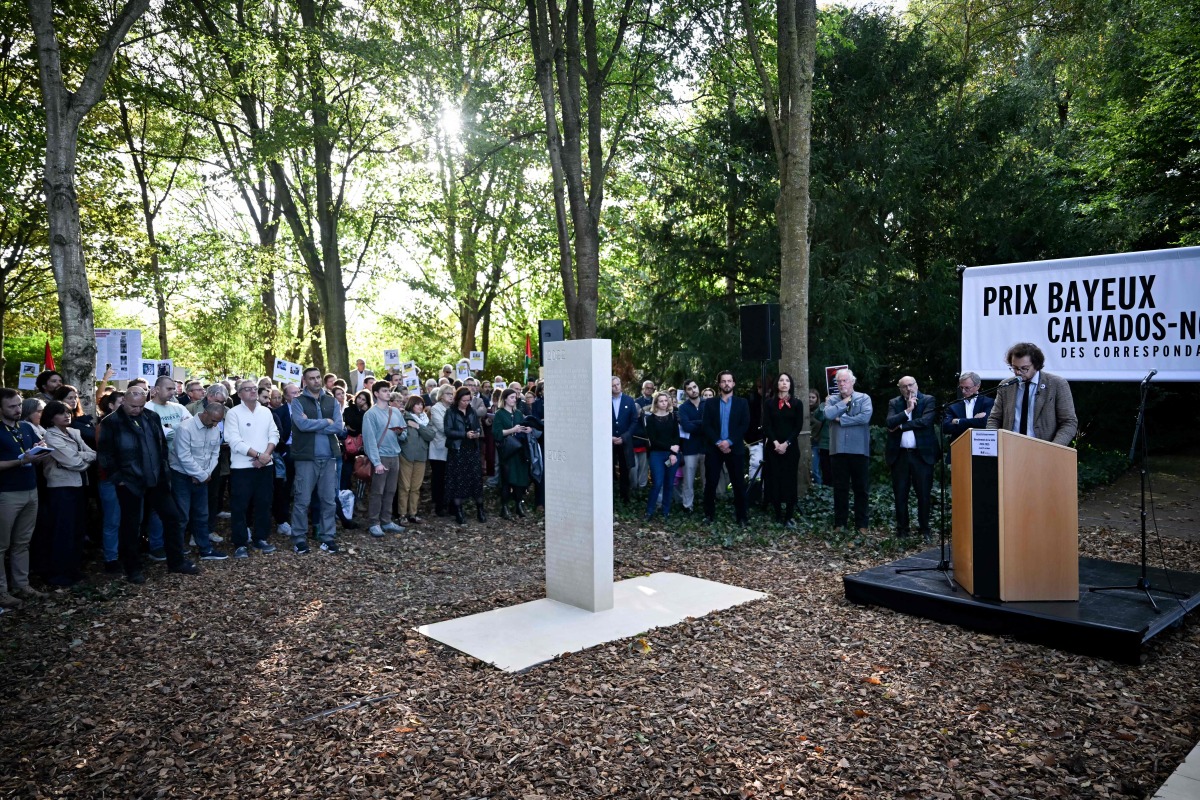 French General Director of RSF Thibault Bruttin addresses the audience during a ceremony next to the 2024-2025 memorial paying tribute to the 73 journalists killed around the world while doing their job during the past year, as part of the 2025 edition of the “Prix Bayeux Calvados-Normandie of the war correspondants”, in Bayeux, northwestern France, on October 9, 2025. (Photo by Lou BENOIST / AFP)