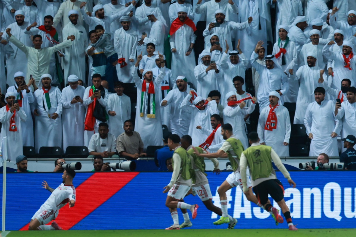 UAE's defender #16 Marcus Meloni (L) celebrates after scoring his team's first goal during the FIFA World Cup 2026 Asian qualifier football match between United Arab Emirates and Oman at Jassim Bin Hamad Stadium in Doha on October 11, 2025. (Photo by Karim JAAFAR / AFP)