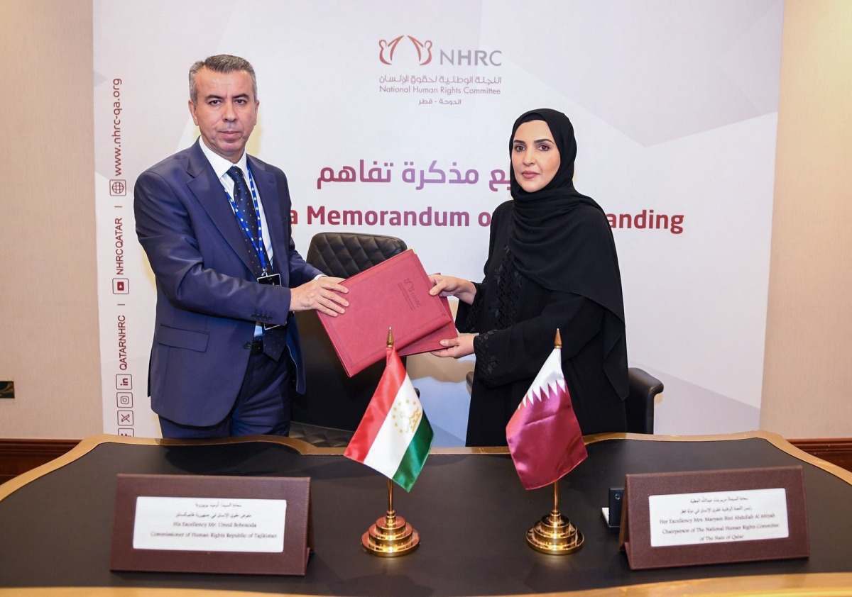 Chairperson of NHRC H E Maryam bint Abdullah Al Attiyah and Commissioner for Human Rights in Tajikistan Umed Bobozod exchanging documents after signing the agreement.