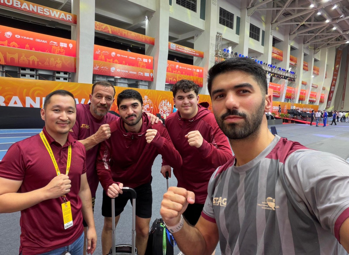 Qatar table tennis players and officials pose for a photo.