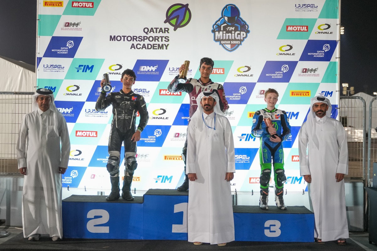 Champion Jake Franklin (top centre), Mohammed Adel Al Mutawa and Anas Boukabache pose for a photo with officials during the presentation ceremony.