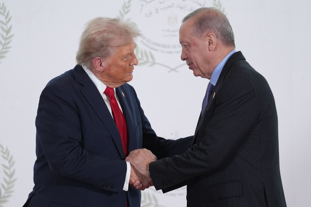 US President Donald Trump and Turkish President Recep Tayyip Erdogan during a summit on Gaza in Sharm el-Sheikh on October 13, 2025. (Photo by Evan Vucci / POOL / AFP)
