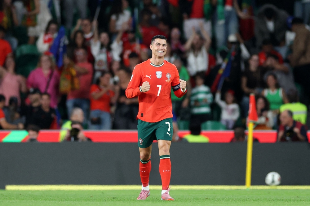 Portugal's forward #16 Cristiano Ronaldo celebrates after scoring the equalising goal during the 2026 World Cup qualifiers Europe zone group F football match between Portugal and Hungary at Jose Alvalade stadium in Lisbon on October 14, 2025. (Photo by Patricia De Melo Moreira / AFP)
