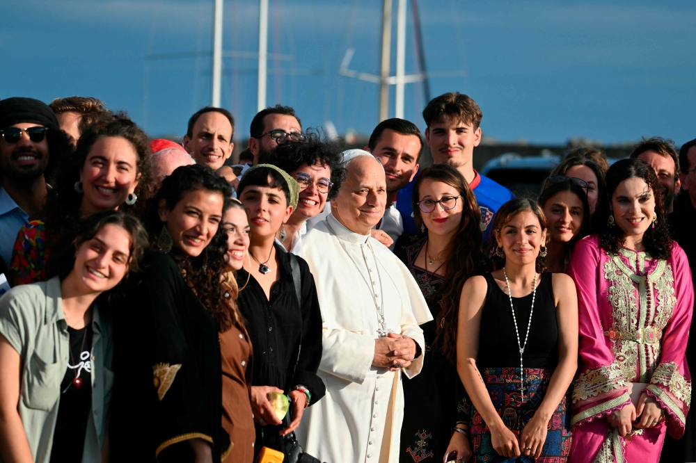 Pope Leo XIV poses with the crew of the Peace training ship 