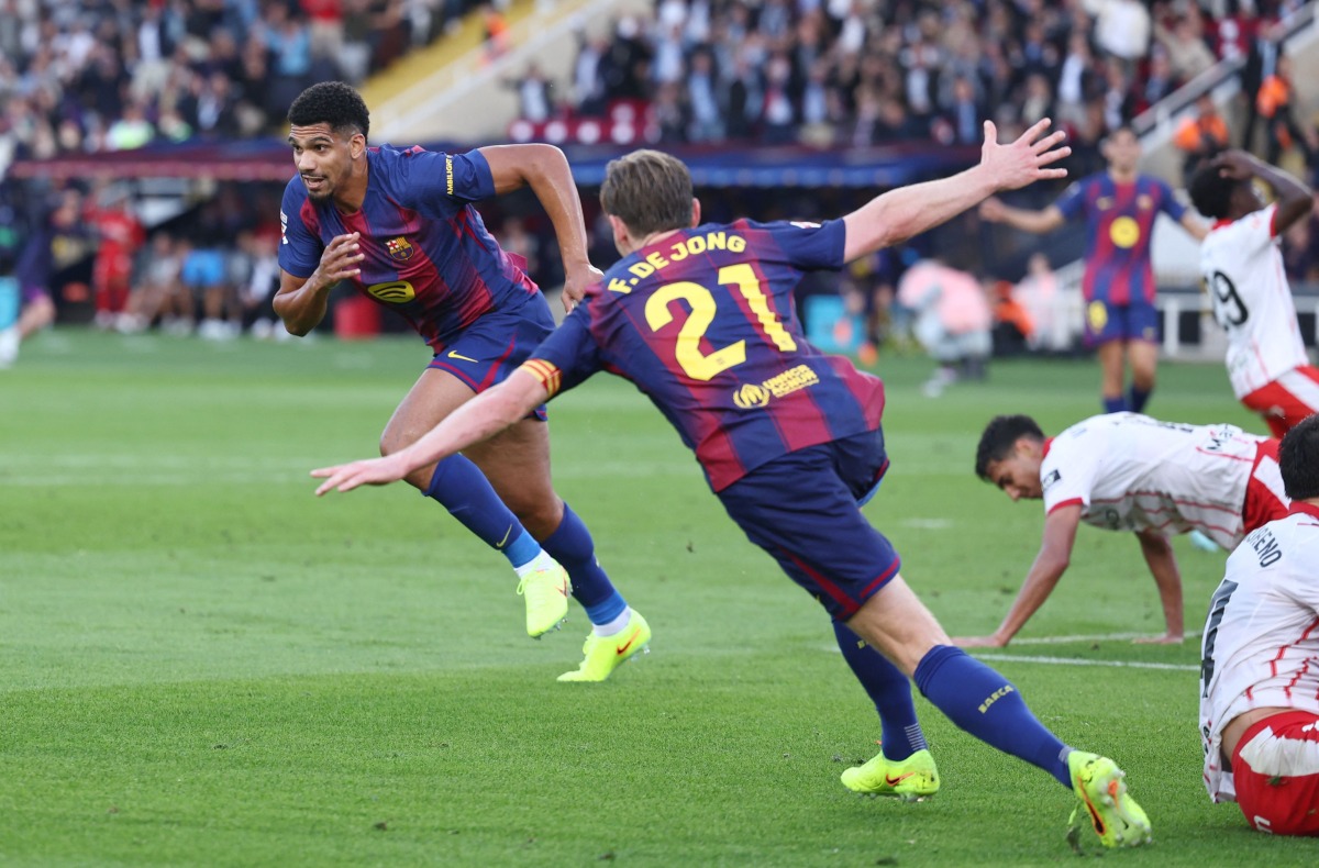 Barcelona's Uruguayan defender Ronald Federico Araujo da Silva celebrates scoring his team's second goal during the Spanish league football match between FC Barcelona and Girona FC at Estadi Olimpic Lluis Companys in Barcelona on October 18, 2025. (Photo by Josep LAGO / AFP)