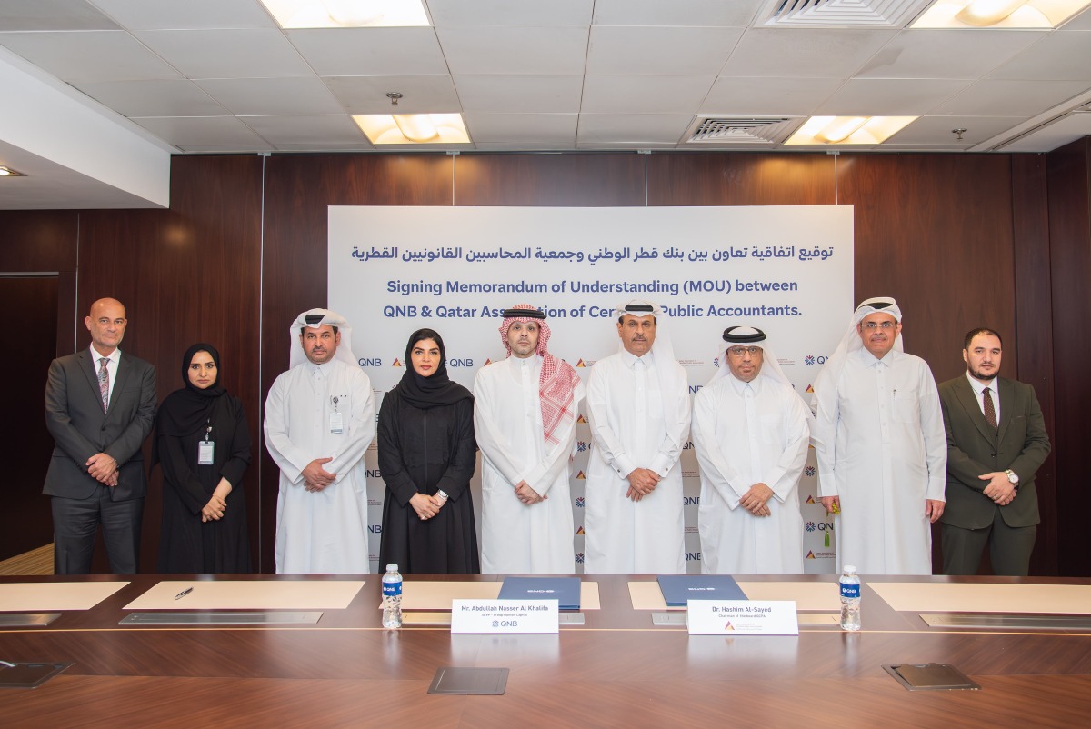 Senior Executive Vice President - Group Human Capital in QNB Group, Abdullah Nasser Al Khalifa, and Chairman of QACPA, Dr. Hashim Al-Sayed, with other officials during the signing of agreement.