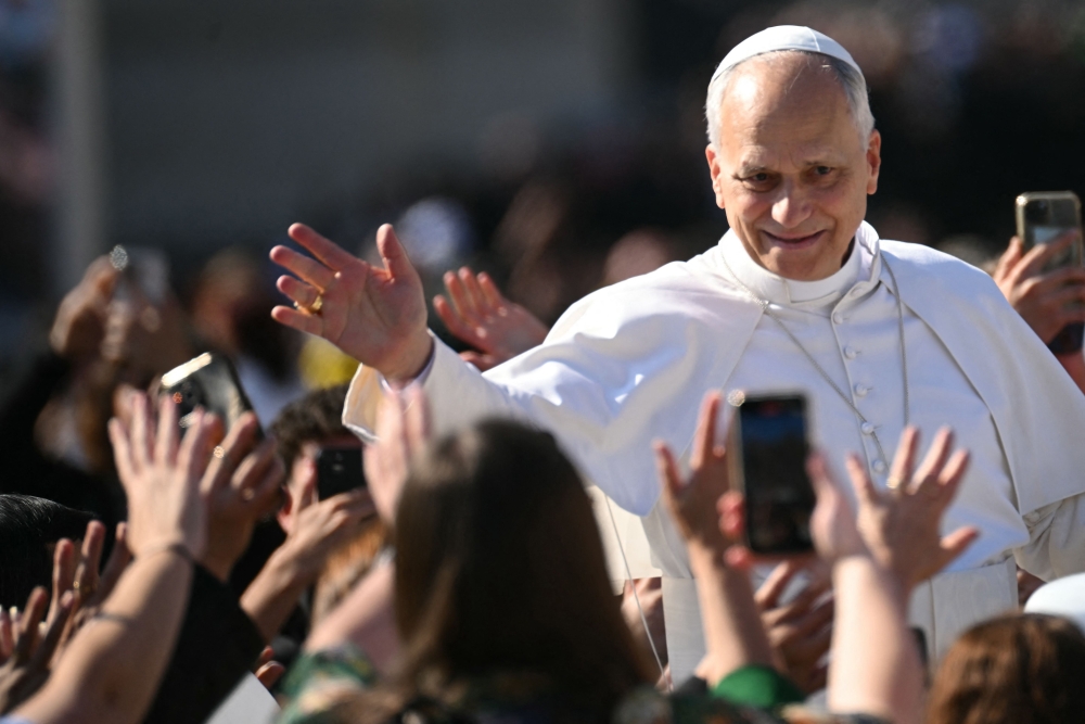 Pope Leo XIV greets the crowd from the Popemobile after a mass for the canonization of seven new Saints at St Peter's square in The Vatican, on October 19, 2025. (Photo by Filippo Monteforte / AFP)