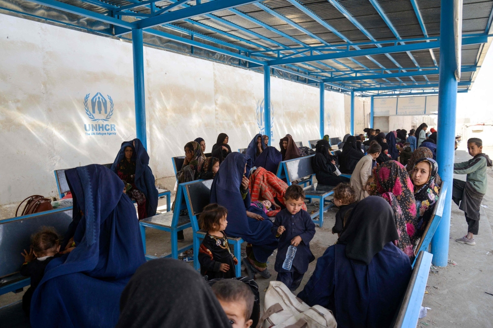 Afghan women and children refugees deported from Pakistan wait inside a registration centre upon their arrival at the zero point border crossing between Afghanistan and Pakistan in the Spin Boldak district of Kandahar province on October 19, 2025. (Photo by Sanaullah Seiam / AFP)

