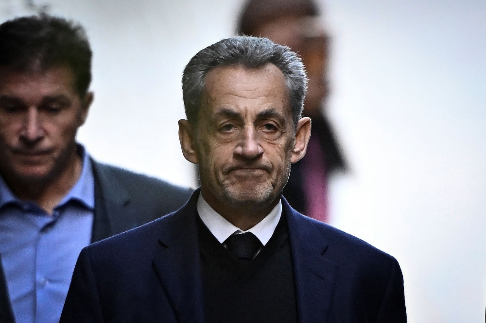 France's former president Nicolas Sarkozy leaves his residence to present himself to La Sante Prison in Paris, on October 21, 2025. Photo by julien de rosa / AFP