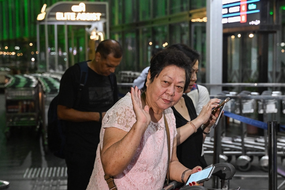 Monica Liu, an Indian citizen and entrepreneur with origins from China, prepares to depart for Guangzhou, from the Netaji Subhas Chandra Bose International Airport in Kolkata on October 26, 2025. (Photo by Dibyangshu Sarkar / AFP)
