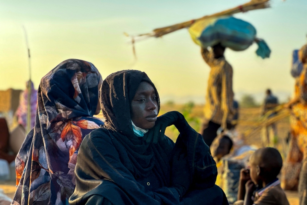 A displaced woman rests in Tawila, in the country's war-torn western Darfur region, on October 28, 2025, after fleeing El-Fasher following the city's fall to the Rapid Support Forces (RSF). (Photo by AFP)