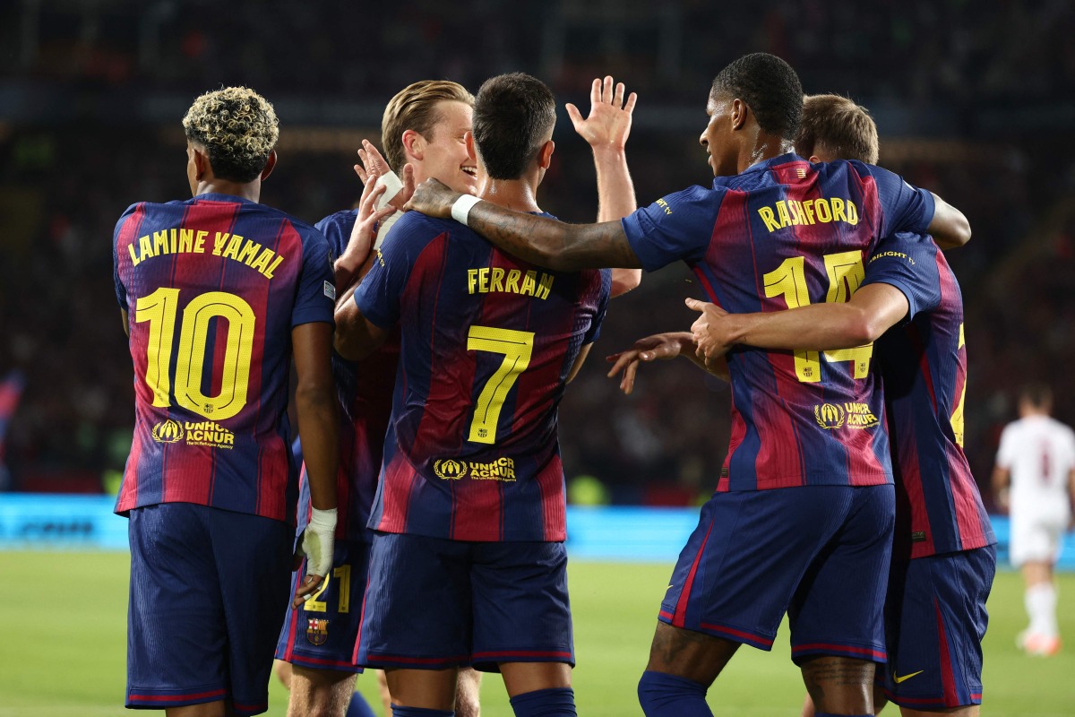 Barcelona's Spanish forward #07 Ferran Torres (C) celebrates with teammates after scoring their first goal during the UEFA Champions League league phase day 2 football match between FC Barcelona and Paris Saint-Germain (PSG) at the Estadi Olimpic Lluis Companys in Barcelona, on October 1, 2025. (Photo by Josep LAGO / AFP)