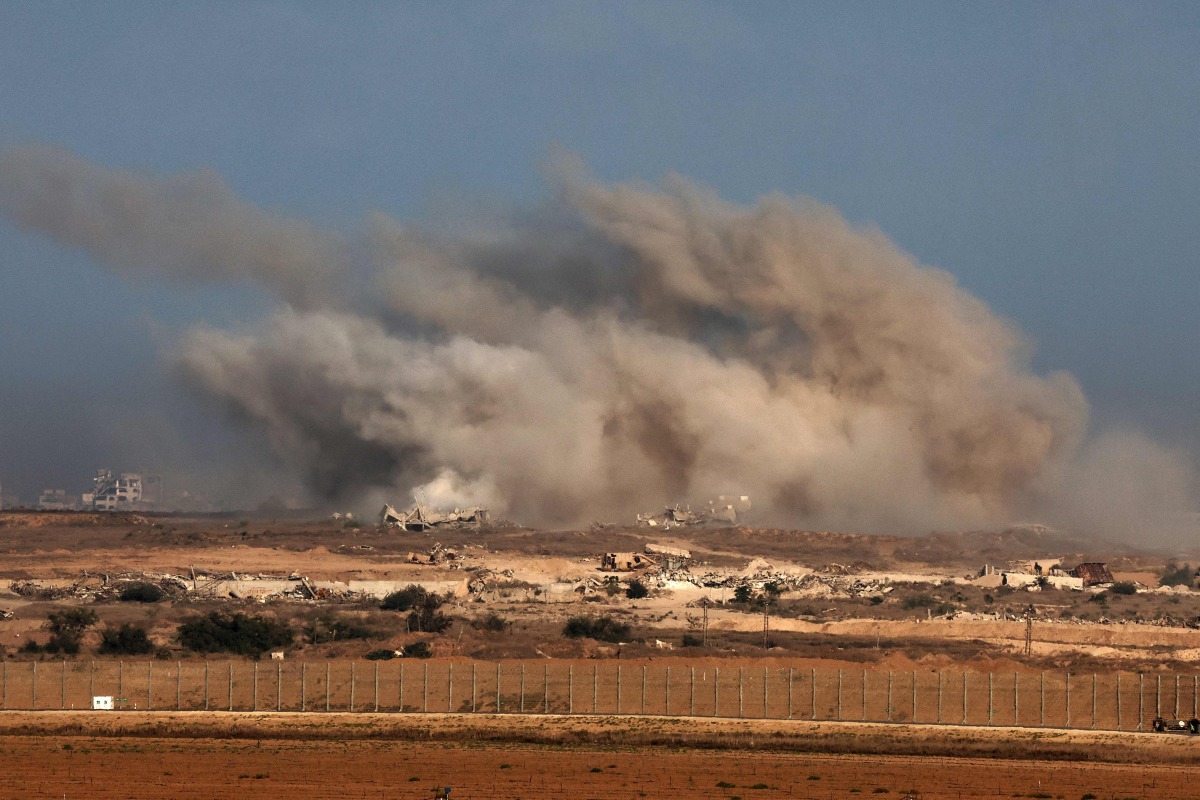 This picture taken from a position at Israel's border with the Gaza Strip shows smoke billowing during an Israeli strike on the besieged Palestinian territory on October 30, 2025. (Photo by Jack GUEZ / AFP)