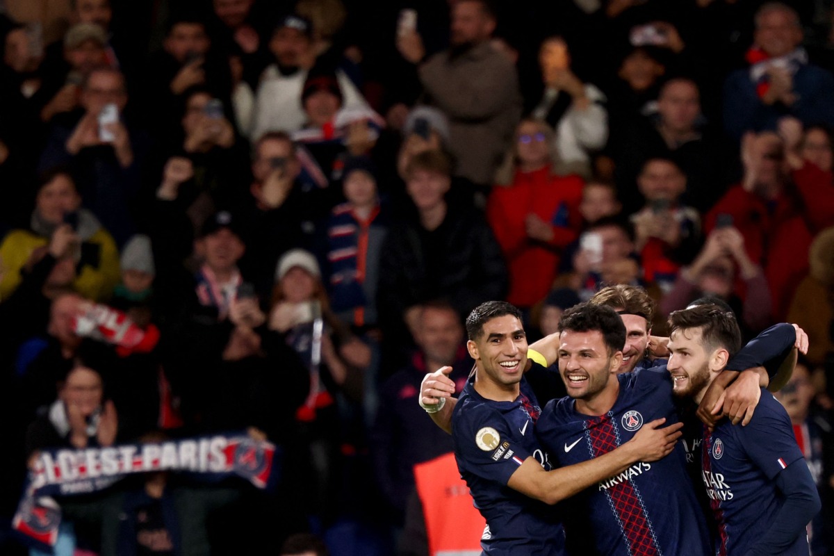 Paris Saint-Germain's Portuguese forward #09 Goncalo Ramos (C) celebrates scoring his team's first goal with Paris Saint-Germain's Moroccan defender #02 Achraf Hakimi (L) and Paris Saint-Germain's Georgian forward #07 Khvicha Kvaratskhelia (R) during the French L1 football match between Paris Saint-Germain (PSG) and OGC Nice at the Parc des Princes stadium in Paris on November 1, 2025. (Photo by FRANCK FIFE / AFP)