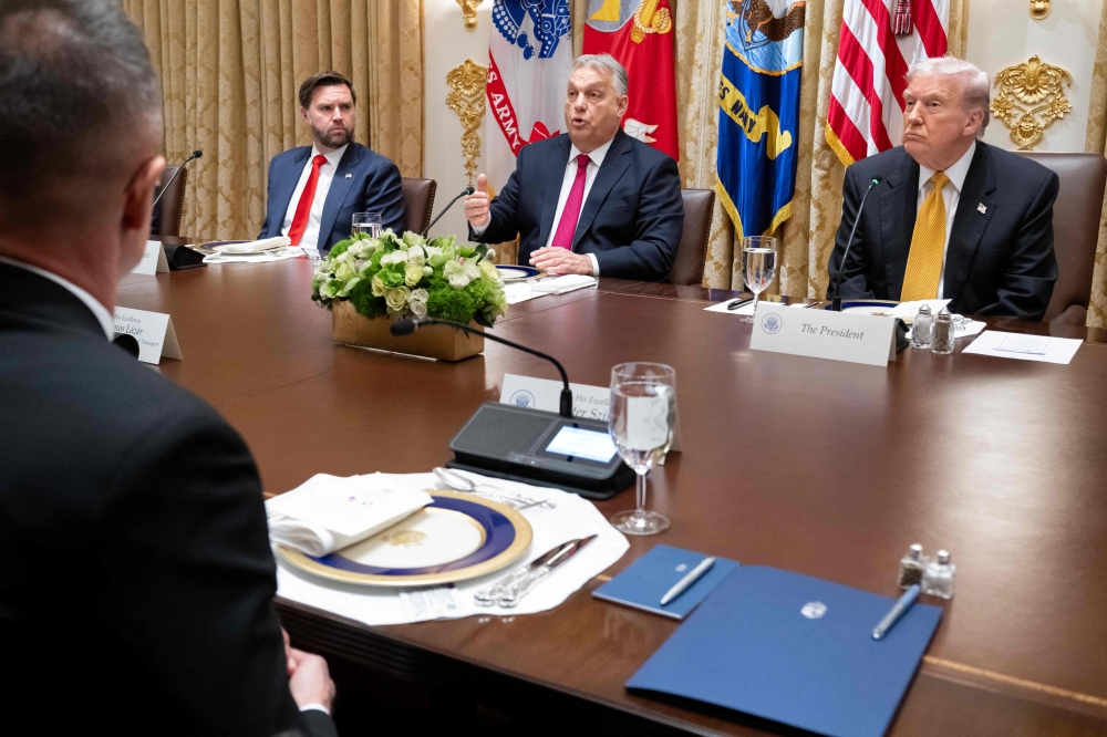 Hungarian Prime Minister Viktor Orban (C) speaks as US Vice President JD Vance (L) and President Donald Trump (R) look on during a meeting in the Cabinet Room of the White House in Washington, DC on November 7, 2025. (Photo by Saul Loeb / AFP)