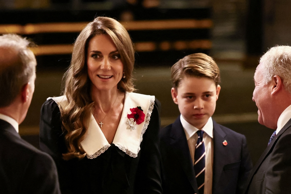 Britain's Catherine, Princess of Wales (L) and Britain's Prince George of Wales (R) arrive to attend The Royal British Legion Festival of Remembrance event at the Royal Albert Hall, in London, on November 8, 2025 ahead of Remembrance Day commemorations. (Photo by Jack Taylor / Pool / AFP)