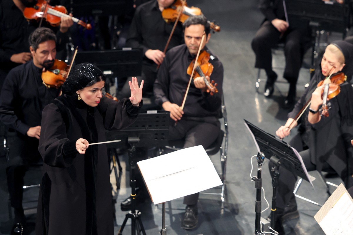 Paniz Faryoussefi, the first woman to conduct the Tehran Symphony Orchestra, leads the ensemble at the Vahdat Hall in Tehran on November 13, 2025. (Photo by AFP)
