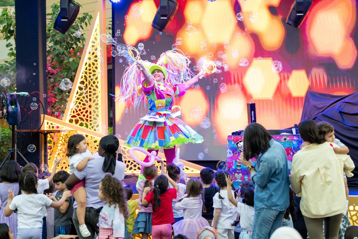 Children watching a performance at the Medina Centrale Carnival.
