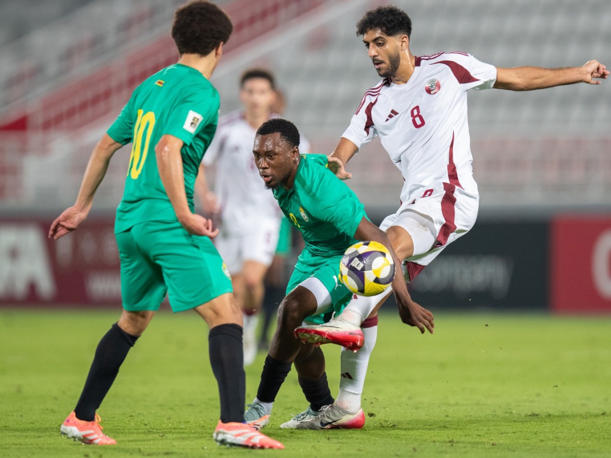 Qatar's Jassem Gaber (right) vies for the ball with Zimbabwe players.