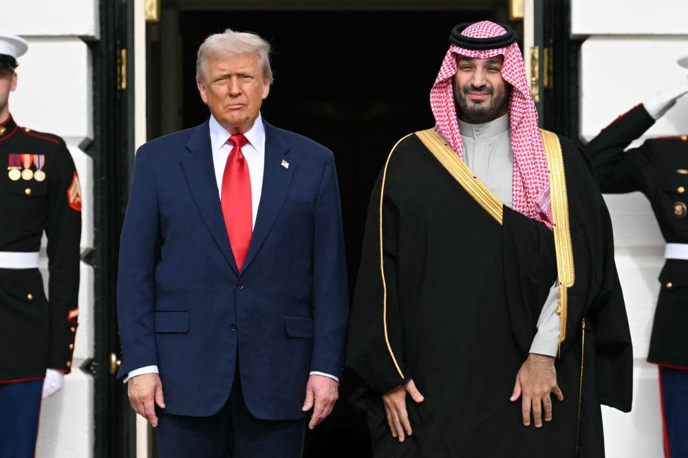US President Donald Trump greets Crown Prince and Prime Minister of the Kingdom of Saudi Arabia Mohammed bin Salman on the South Lawn at the White House in Washington, DC on November 18, 2025. Photo by Saul Loeb / AFP