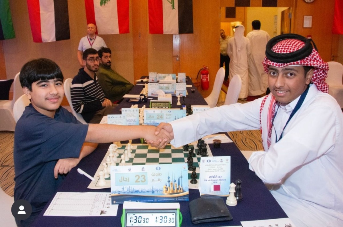 Qatar's Hamad Al Kuwari (right) shakes hand with Kuwait's Hussein Suleiman before the start of their second round match.
