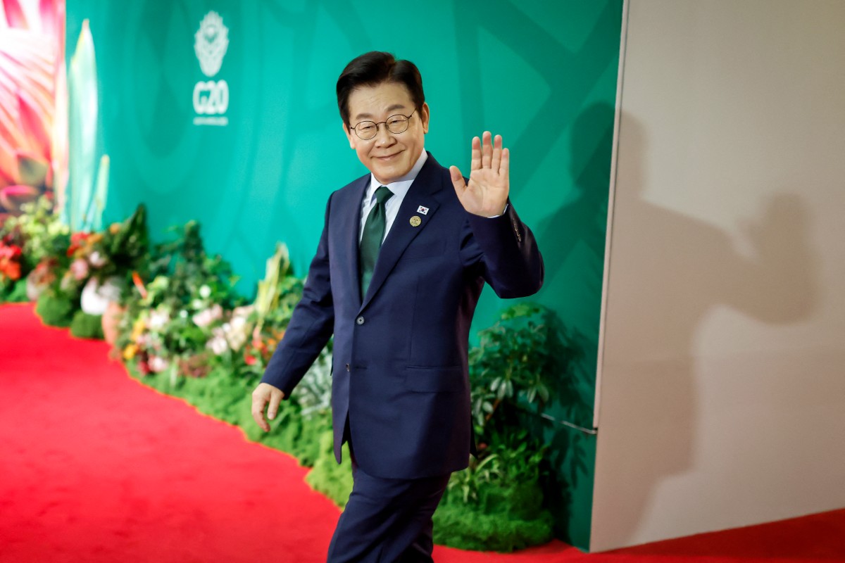 South Korea's President Lee Jae Myung arrives for the second day of the G20 Leaders' Summit at the Nasrec Expo Centre in Johannesburg on November 23, 2025. (Photo by Marco Longari / Pool / AFP)
