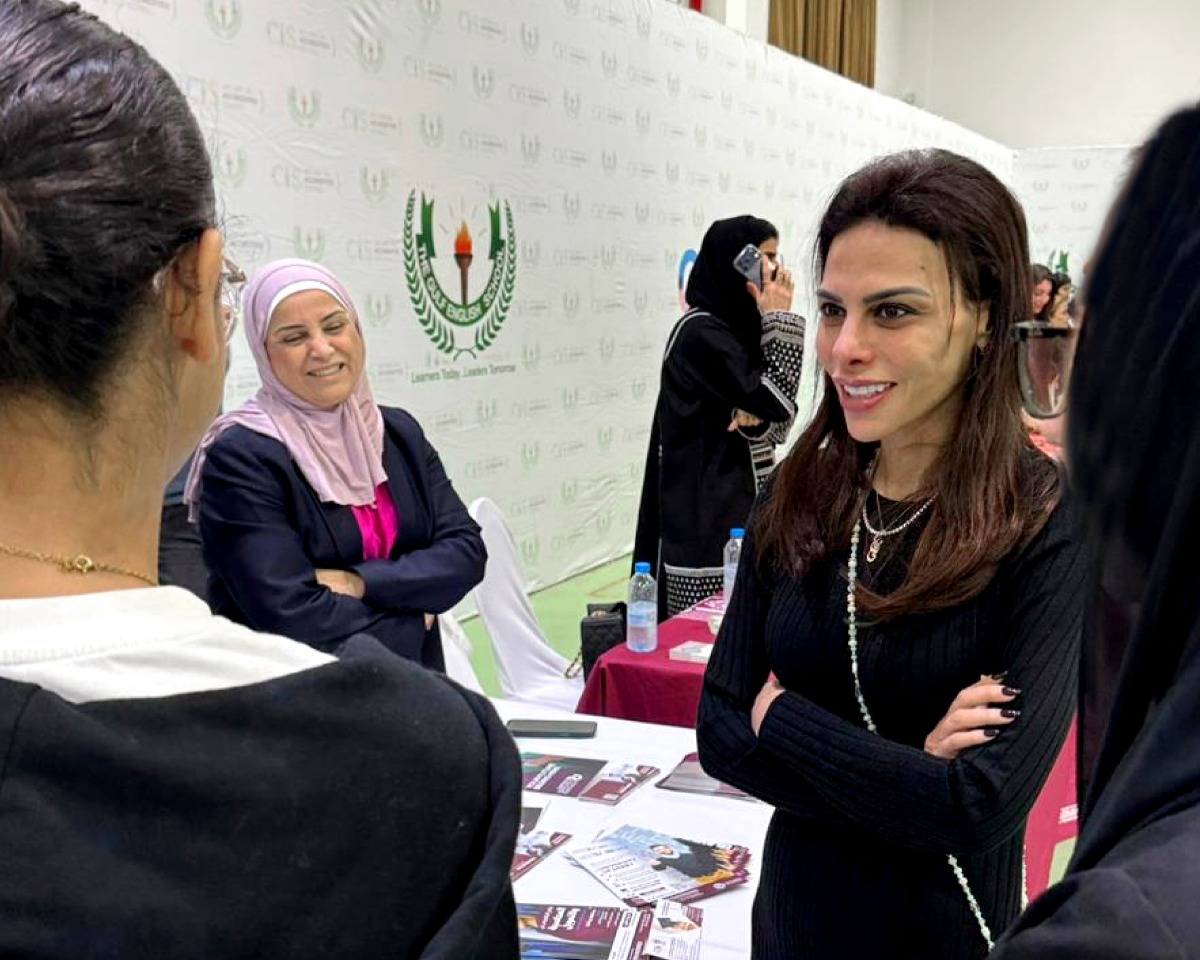 Students interacting with university representatives. 
