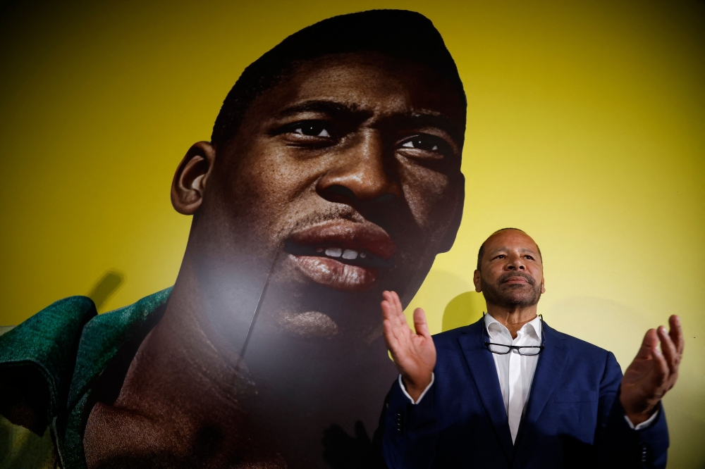 Neymar Santos SR, father of Brazilian forward Neymar Jr and owner of NR Sports, gestures to the media at the announcement of the acquisition of late Brazilian football legend Pele brand at the Pele Museum, in Santos, Sao Paulo, Brazil on November 25, 2025. (Photo by Miguel SCHINCARIOL / AFP)