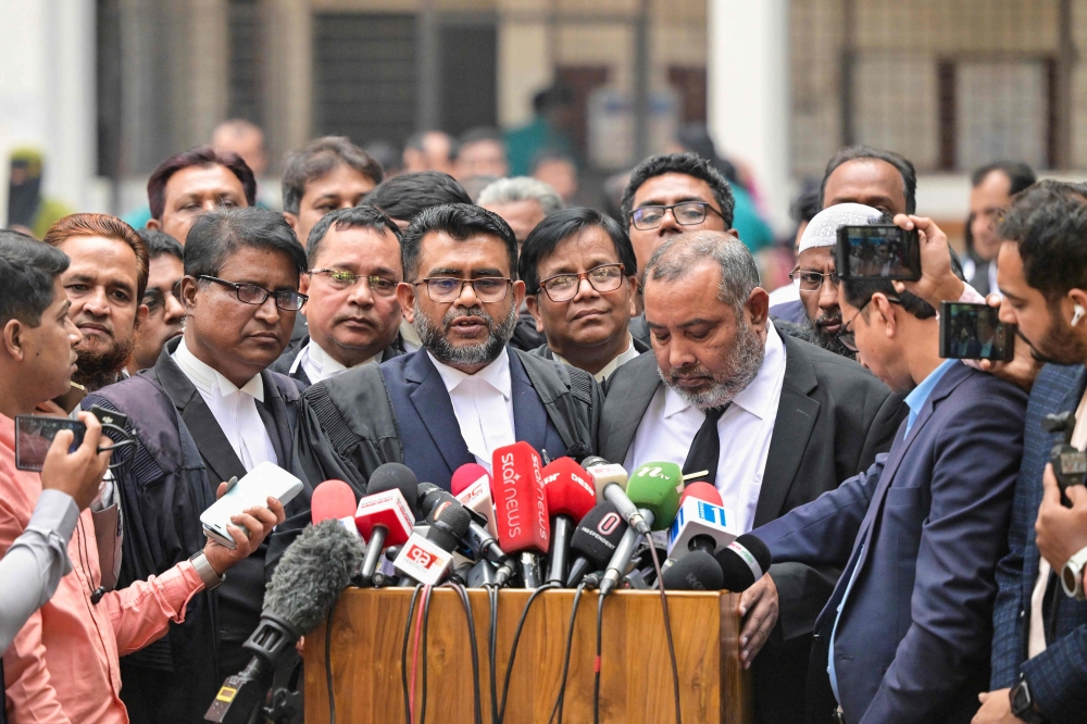 prosecutor for the Anti-Corruption Commission Khan Mainul Hasan (C), addresses the media at a court premises in Dhaka on December 1, 2025. (Photo by Munir Uz Zaman / AFP)