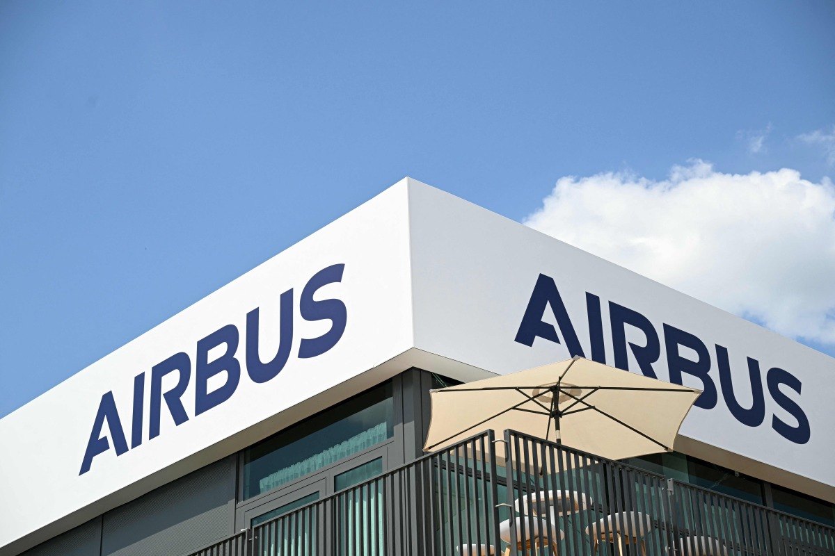 (FILES) The logo of Aerospace company Airbus is displayed at the Pavillon Airbus during the 55th edition of the International Paris Air Show at the Paris Bourget Airport, in Le Bourget, suburb of Paris on June 17, 2025. (Photo by Bertrand GUAY / AFP)