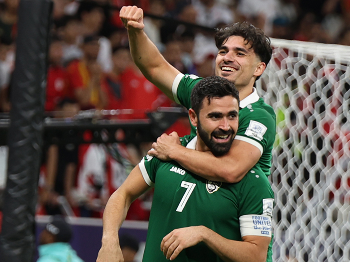 Omar Khribin (foreground) celebrates with a teammate after scoring a goal. 