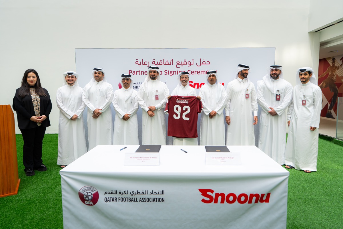 QFA and Snoonu officials during the signing ceremony.
